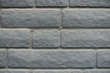 Macro of dusty black painted brick veneer wall