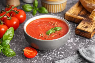 Bowl of delicious tomato soup on grunge background