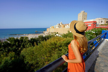 Summer holiday in Italy. Attractive young traveler woman visiting Termoli village in Molise region,...