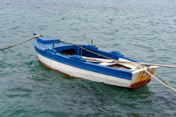 Lonely boat, small old blue and white fishing boat in the beautiful blue waters of the Croatian...