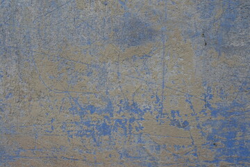 Surface of blue and yellow old, faded and scratched painted wall