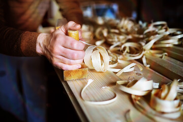 Hand planer with wooden sawdust. On a wooden background. High quality photo