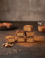 Sliced chocolate candy with nuts on the brown table