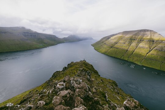 Ridgeline on Klakkur mountain in the Faroe Islands with the sea and other islands in the background
