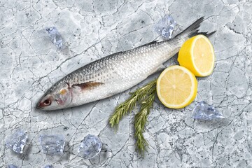 Fresh tasty fish for cooking dish on table with lemon