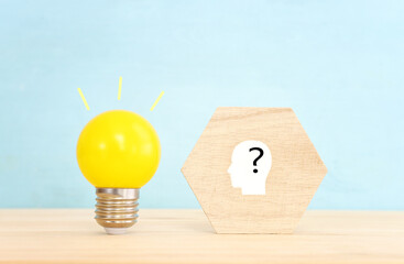 Education and human resource concept image. Creative idea and innovation. light bulb metaphor over blue background, wooden cubes and people icons