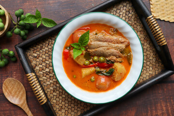 Roast duck red curry - Thai food called Kang Pled Ped Yang at top view on bamboo tray, Flat lay food