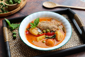 Roast duck red curry - Thai food called Kang Pled Ped Yang at close up view on bamboo tray