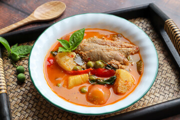 Roast duck red curry - Thai food called Kang Pled Ped Yang at close up view on bamboo tray