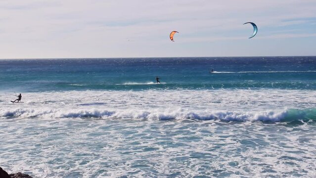 The kite-surfing surfer sails on the ocean wave. Spain. Tarifa.
