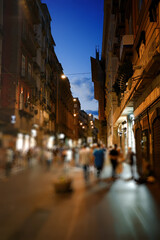Fototapeta na wymiar Crowdy evening street in Naples, Italy.