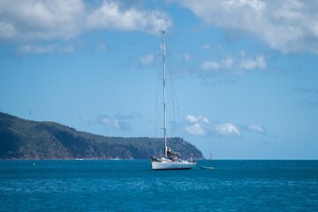 tourist boats and tour boats in the whitsundays queensland, australia. travellers on the great barrier reef, over coral and fish. tourism yachts of young people partying on the water