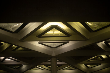 Light triangle. Lamp on ceiling. Light design. Architecture of 20th century.