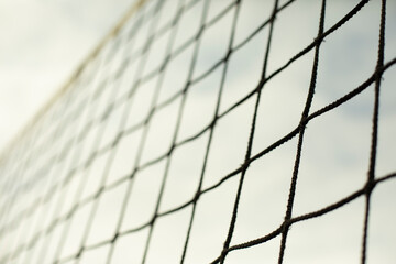 Sports net. Volleyball equipment. Grid against sky.