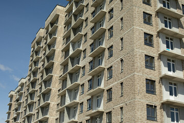 Fototapeta premium Building in city. Architecture details. Lots of windows in house.