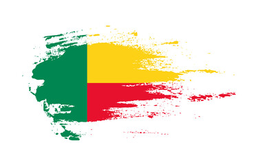 Grunge brush stroke flag of Benin with painted brush splatter effect on solid background