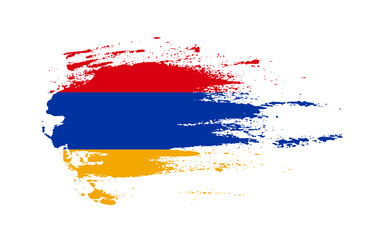 Grunge brush stroke flag of Armenia with painted brush splatter effect on solid background