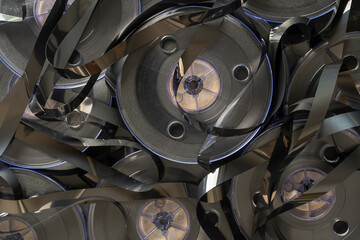 Vintage magnetic video reels on background. Old retro bobbins with magnetic tapes, closeup