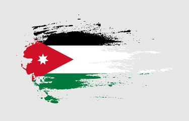 Fototapeta na wymiar Grunge brush stroke flag of Jordan with painted brush splatter effect on solid background