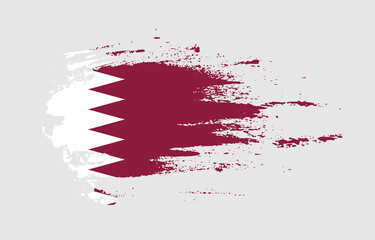 Grunge brush stroke flag of Qatar with painted brush splatter effect on solid background