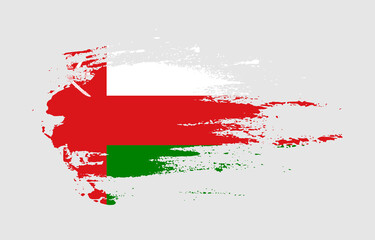 Grunge brush stroke flag of Oman with painted brush splatter effect on solid background