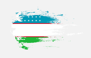 Fototapeta premium Grunge brush stroke flag of Uzbekistan with painted brush splatter effect on solid background