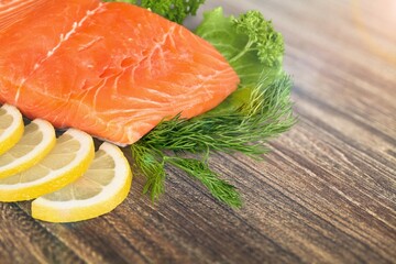 Fresh tasty fish for cooking dish on table with lemon