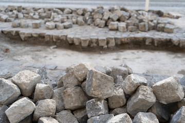 Reconstruction of Grey Old Stone Pavement, Granite Cobblestone Road under Construction