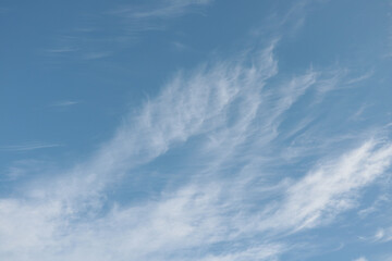Naklejka na ściany i meble Light blue sky with white clouds. Nature background.