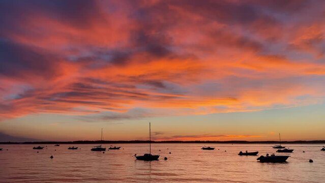 Beautiful sunset on the Arcachon Bay on a summer evening with boats on the water