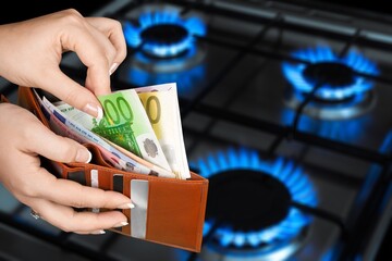 Blue fire on gas burner and paper money