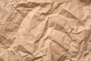 Brown crumpled recycled paper texture background. Textured paper background. Kraft Paper texture background of brown crumpled recycled cardboard paper sheet