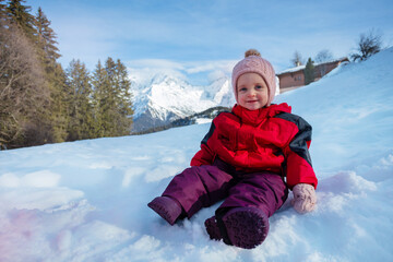 Fototapeta na wymiar Portrait of a happy young girls sit in snow wear winter outfit