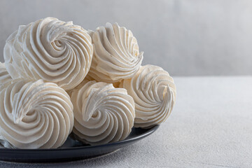 delicious zephur on a plate standing on a light marble background. homemade desserts, pastry shop, pastry chef, holiday, birthday, valentine's day, confectionery products, tea party concept
