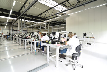 workers in a factory for the production of electronics - modern industrial enterprise