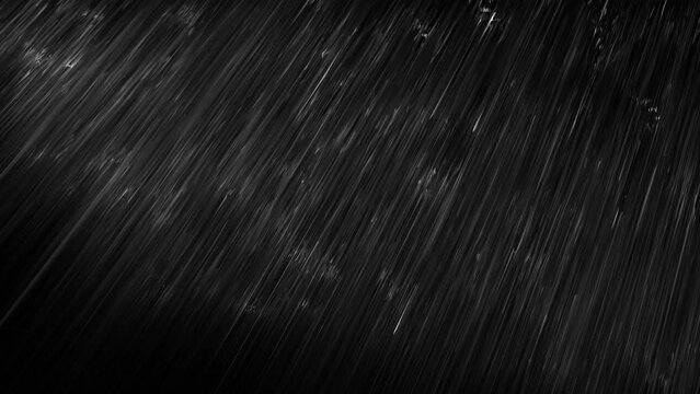 黒い背景に雨が降るループ映像