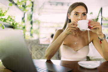 Businesswoman having a coffee while working from a cafe.