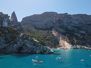 Fototapeta premium Aerial view of the famous Cala Goloritze in Orosei Gulf, East Sardinia, Italy. Drone and birds eye of clear and crystalline water over the top of Punta Salinas, Sardinia (Sardegna).