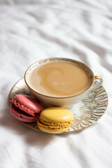 morning coffee with macaroons on sheets. coffee in bed