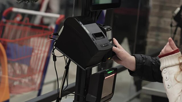 Buyer enters password PIN code at cashless payment terminal. Customer uses self-service checkout ACO in supermarket. Assisted checkout SCO. Shopping at mall and store. Self-checkout