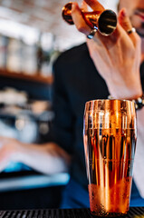 man hand bartender making cocktail with shaker on the bar counter