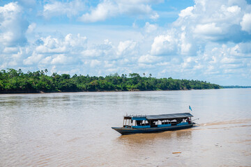 riverbank view of peruvian amazon with shanty houses at background
