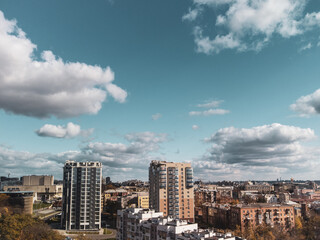 City aerial view, residential buildings in autumn with scenic cloudy blue sky, sunny downtown. Kharkiv, Ukraine