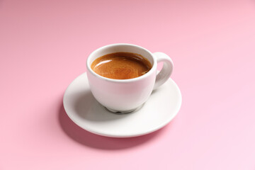 White cup of coffee espresso isolated on pink background