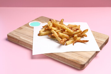 Homemade French fries on rustic wooden table