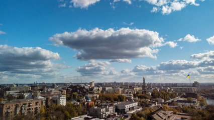 Kharkiv city center aerial, rooftop view on residential buildings, Lopan river, Cathedrals and national flag pole in autumn with scenic blue sky. Ukraine