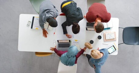 Teamwork, brainstorming and collaboration with team overhead planning and writing ideas in a corporate office. Busy, inclusive and professional group sharing goal and vision for mission target