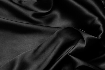 Part of the dark fabric texture of the fabric for the background and decoration of the work of art, a beautiful crumpled pattern of silk or linen. A crumpled piece of cloth