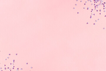 Frame made of silver crystal confetti on a pink background. Concept with copy space.