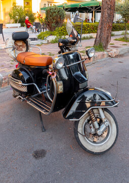 Loutra Edipsou, island Evia, Greece. September 2022: Black Retro scooter Vespa in the street 